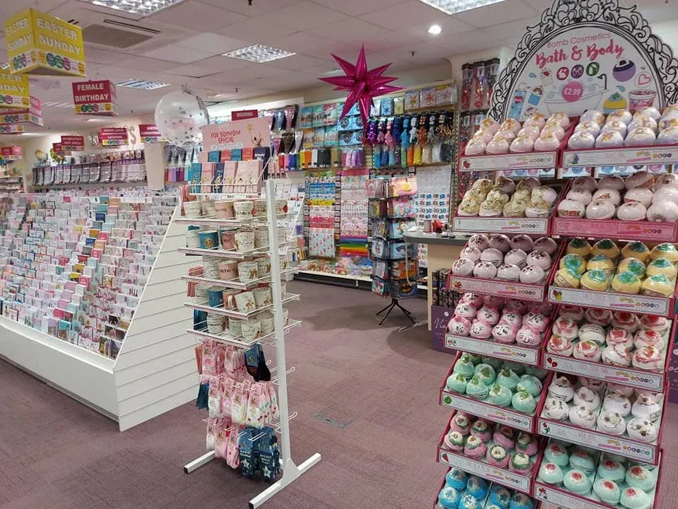 Card fixtures beside a bath and body stand, under Easter Sunday and Female Birthday signs