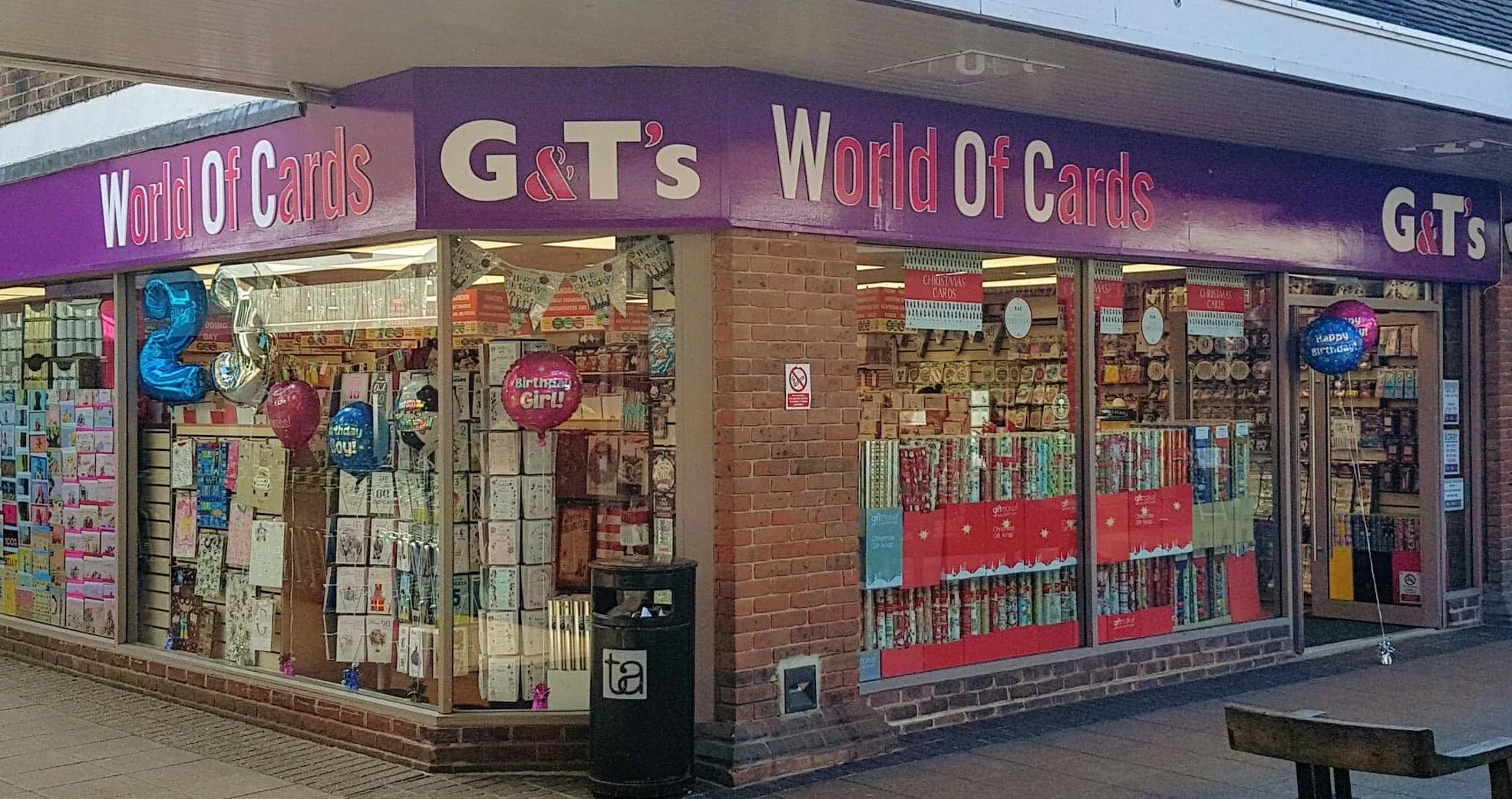 A double-fronted shop under a canopy, the purple fascia running the full width